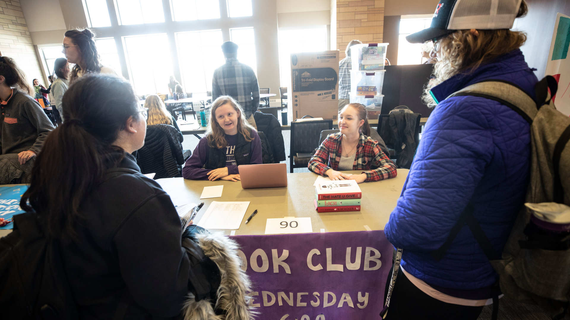 Members of the Book Club talk to students during an Activities Fair