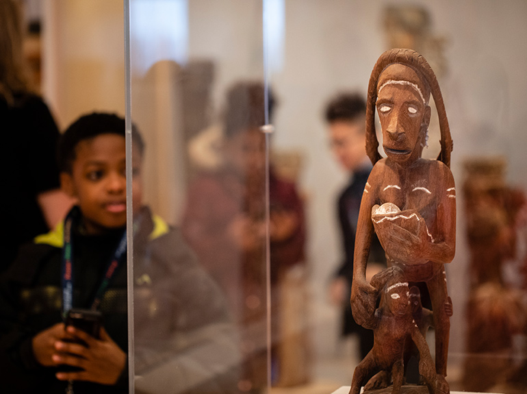 A child looks at a display during a visit to the Asmat Art Gallery.