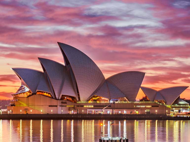 Stock photo of the Sydney Opera House in Sydney, Australia at sunset. 