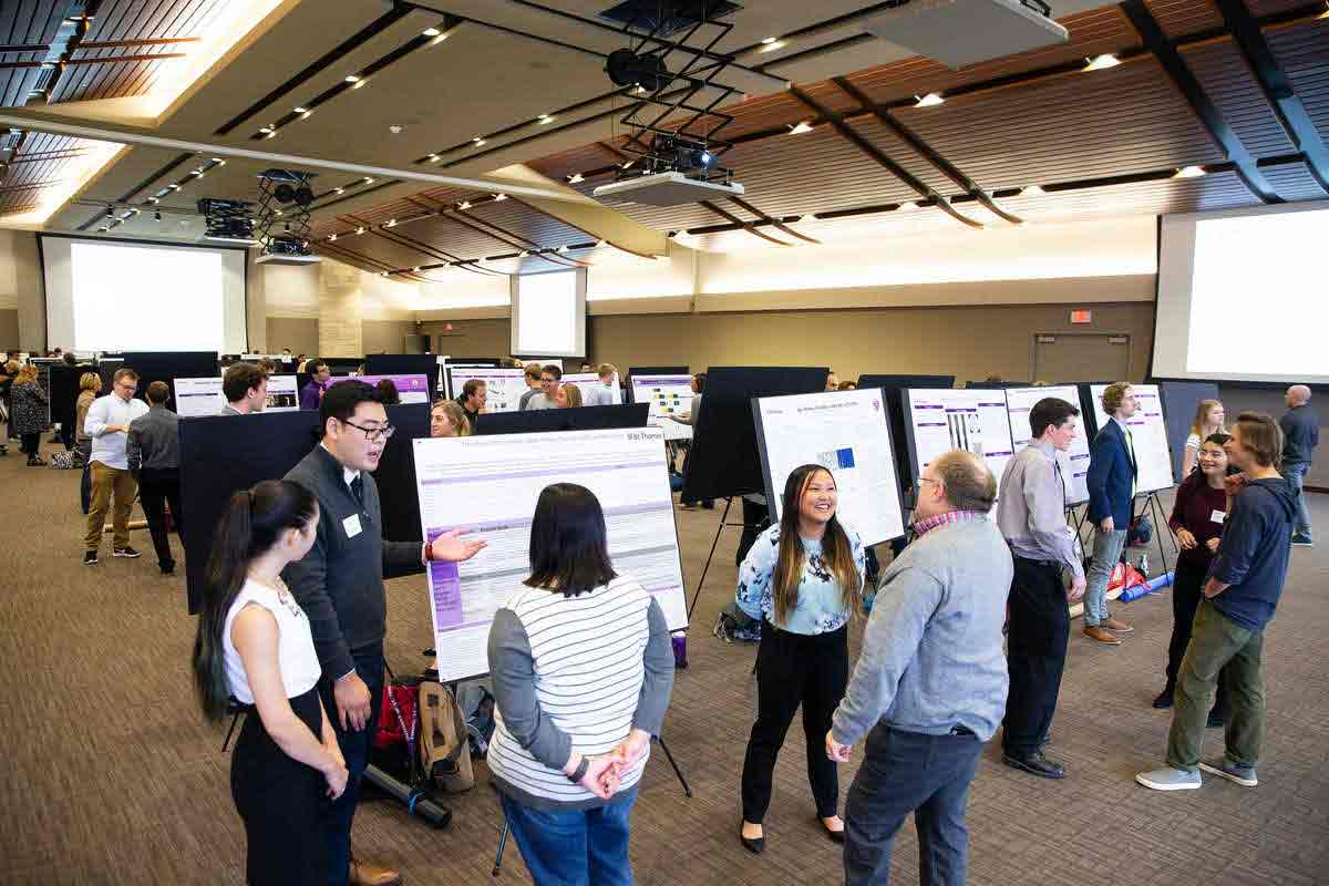 Students presenting capstone projects in Woulfe Alumni Hall