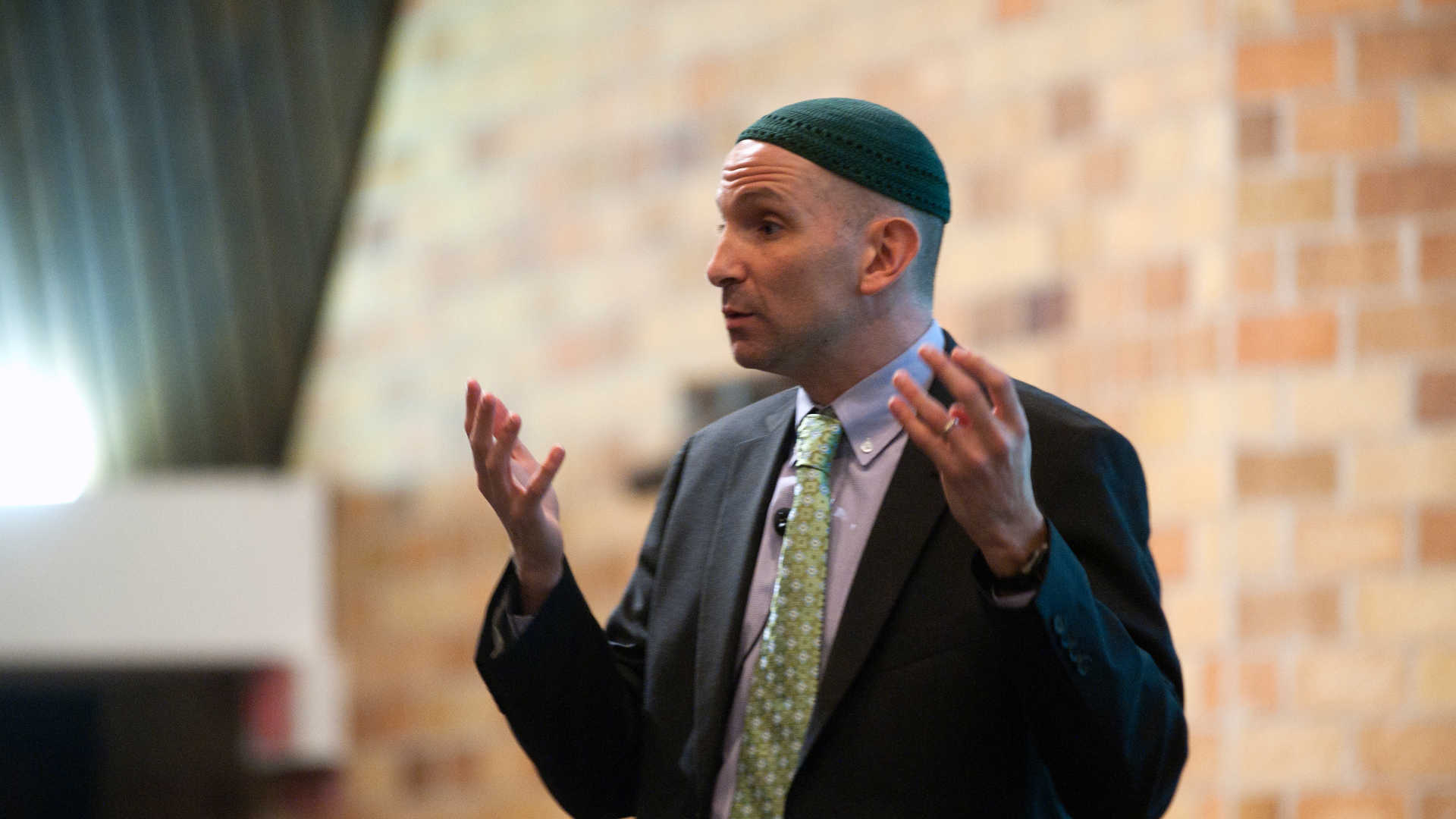 Rabbi Will Berkowitz speaks at an event.