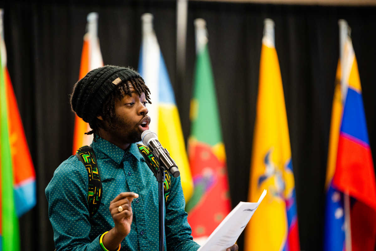Keanu Daley performs his poem about Jamaica during International Dinner.