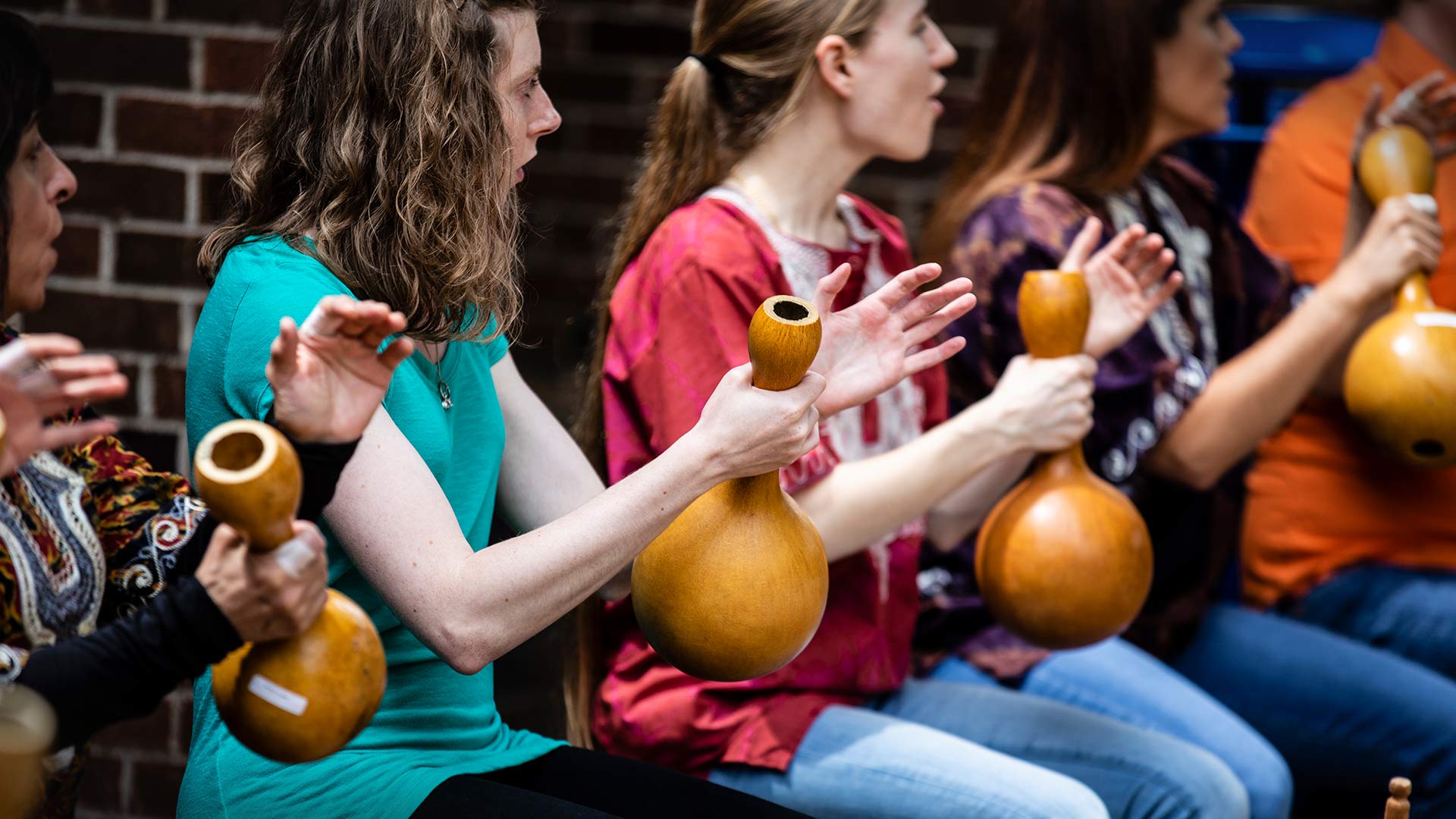 Student playing gourds.