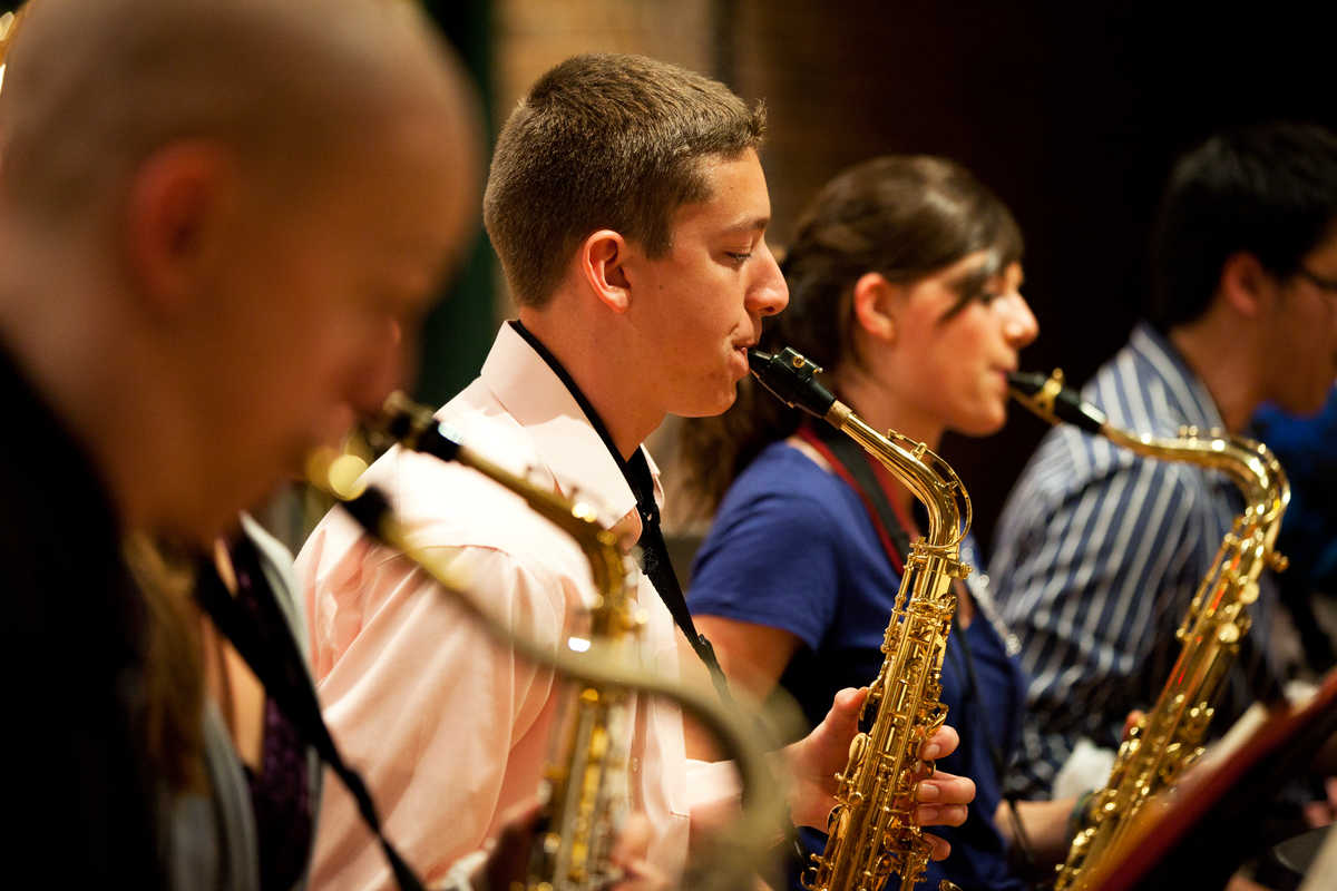 Students play the saxophone during a concert.
