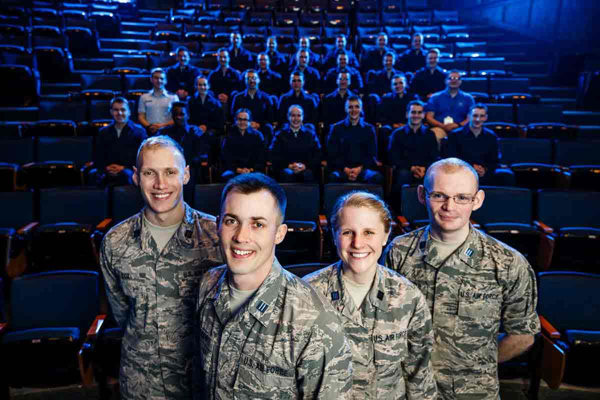 Four cadets pose in front of a classroom of fellow cadets in Saint Thomas John Roach Center.