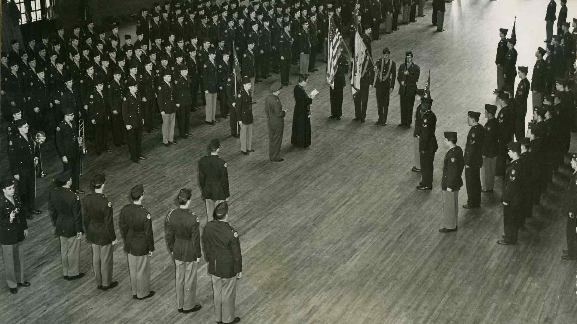 Black and white photo of a formation of cadets in “The Armory.”