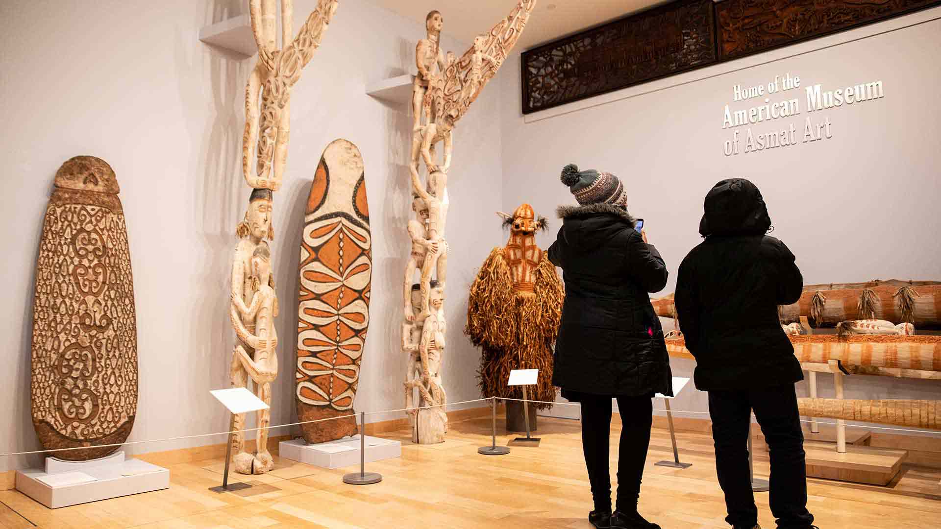 Two students standing in the American Museum of Asmat Art