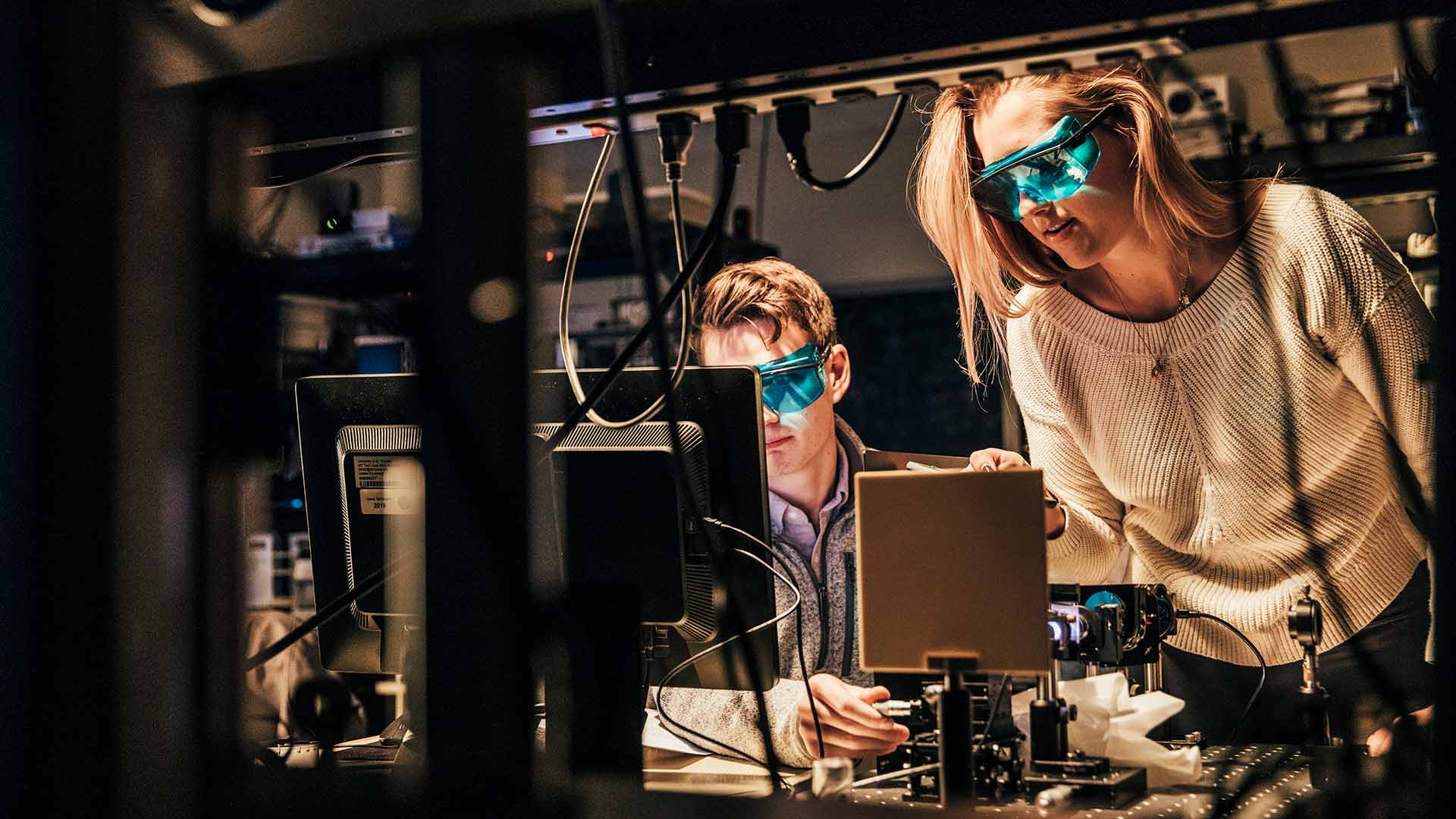 Students work on with lasers in a Physics Lab.