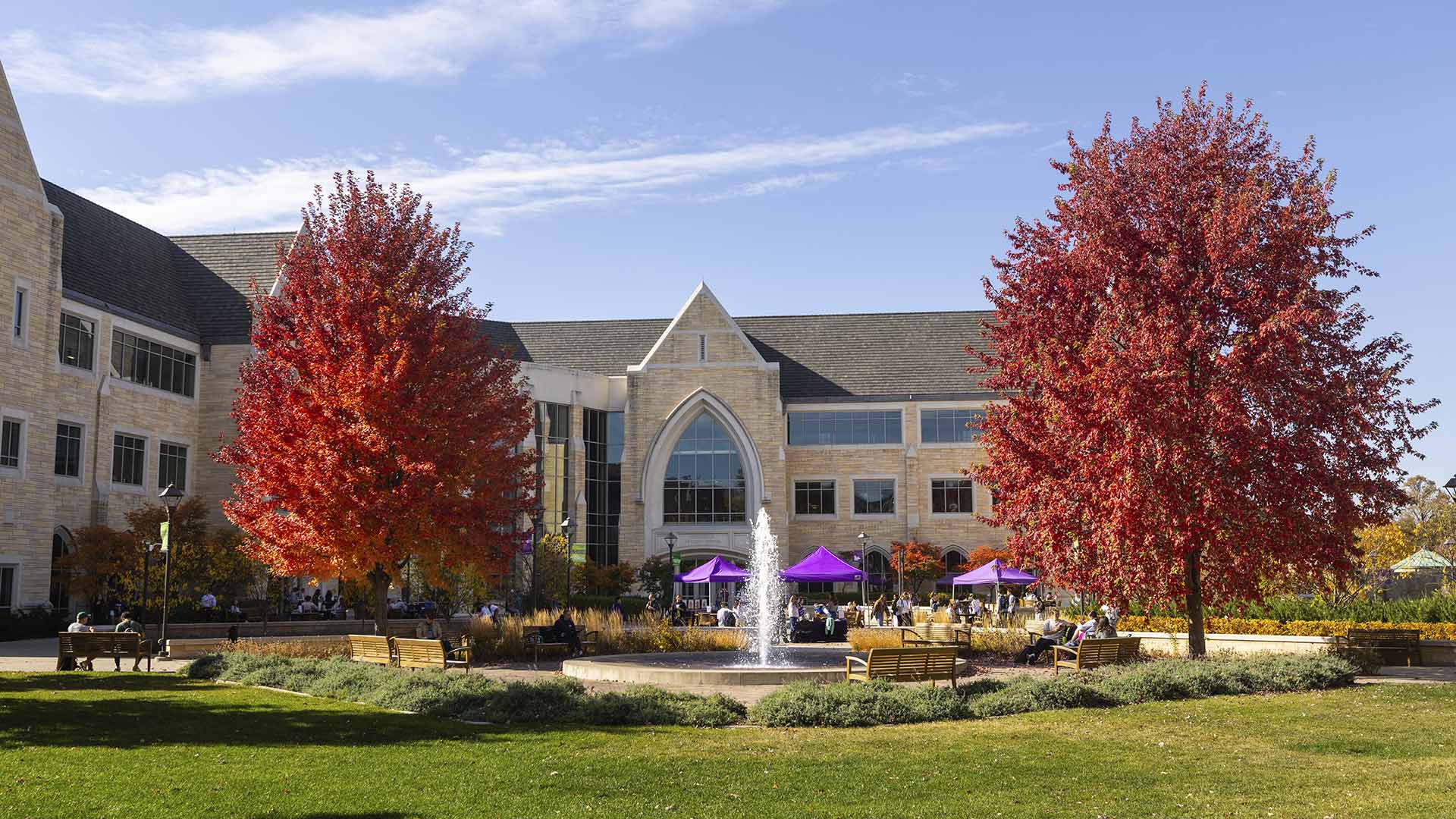 The St. Thomas campus in autumn, with trees showing vibrant red leaves