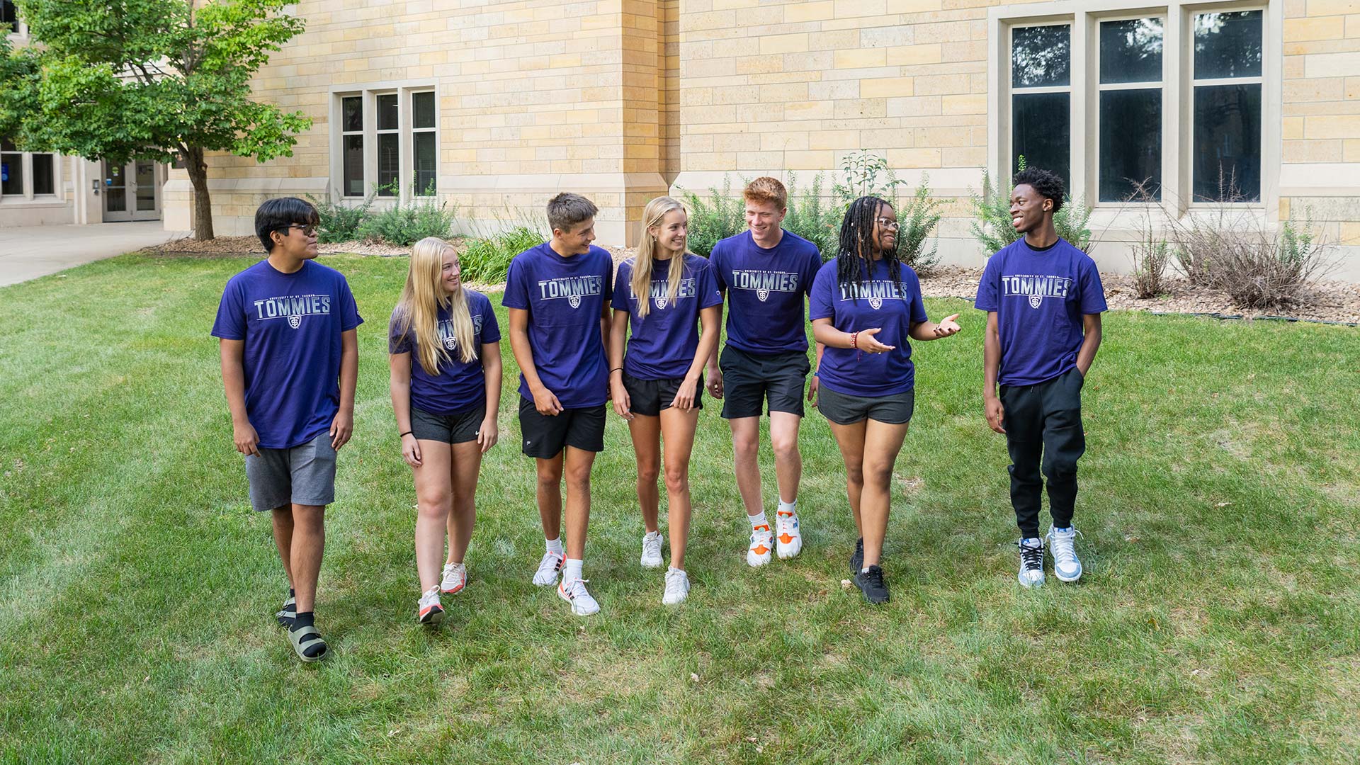 The 2023 NSF Discovery Scholars walk on the lawn on the St. Thomas Campus