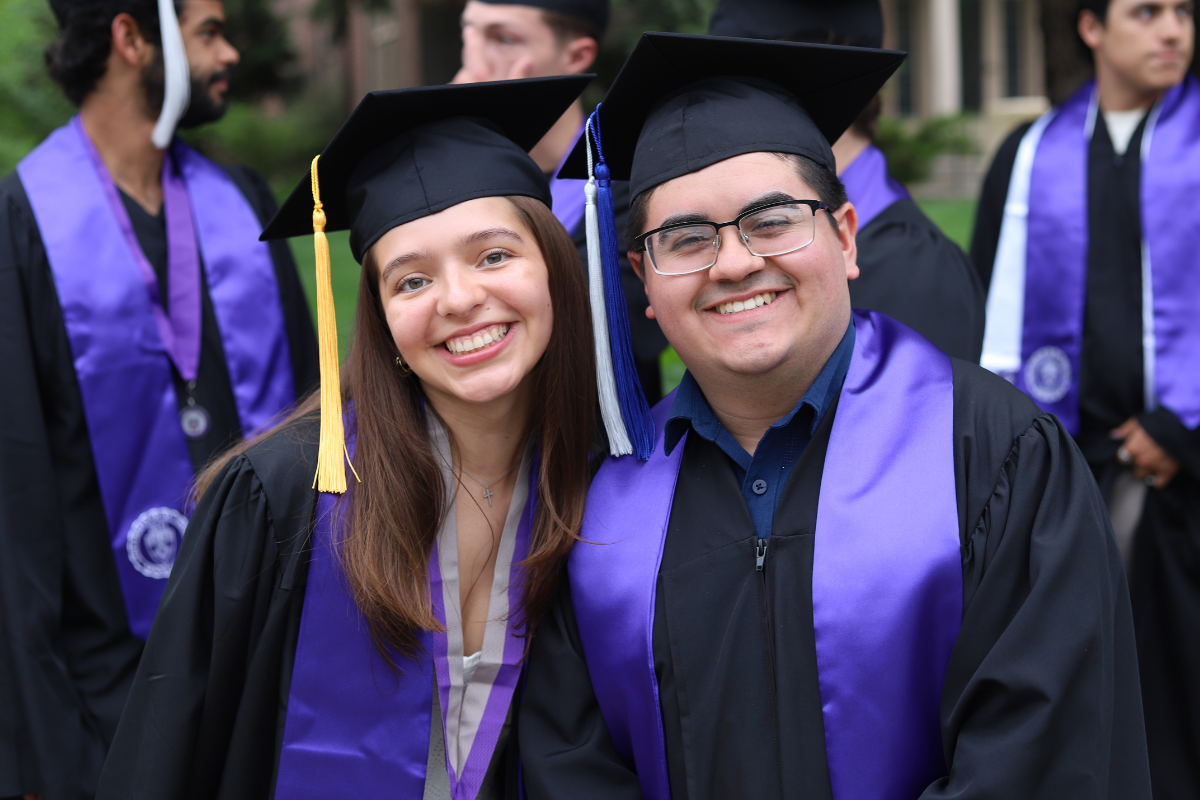 Students in their caps and gowns celebrate at graduation