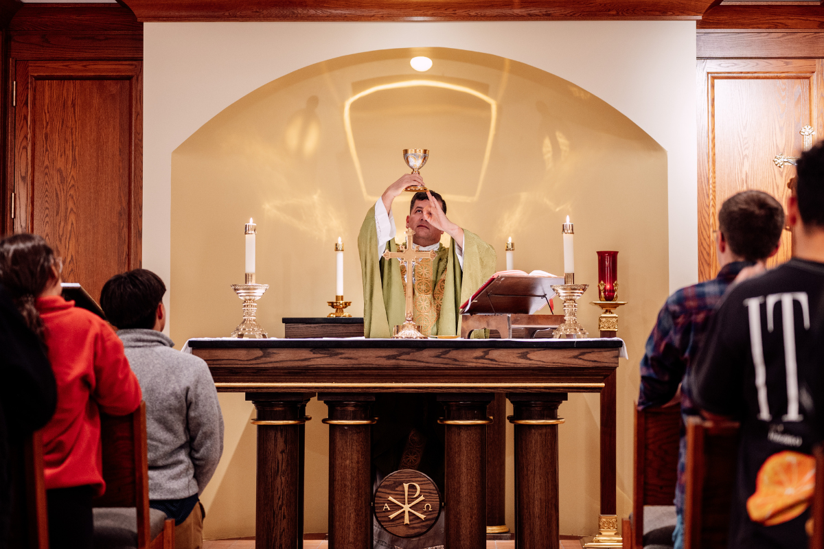 A priest prepares communion at the altar