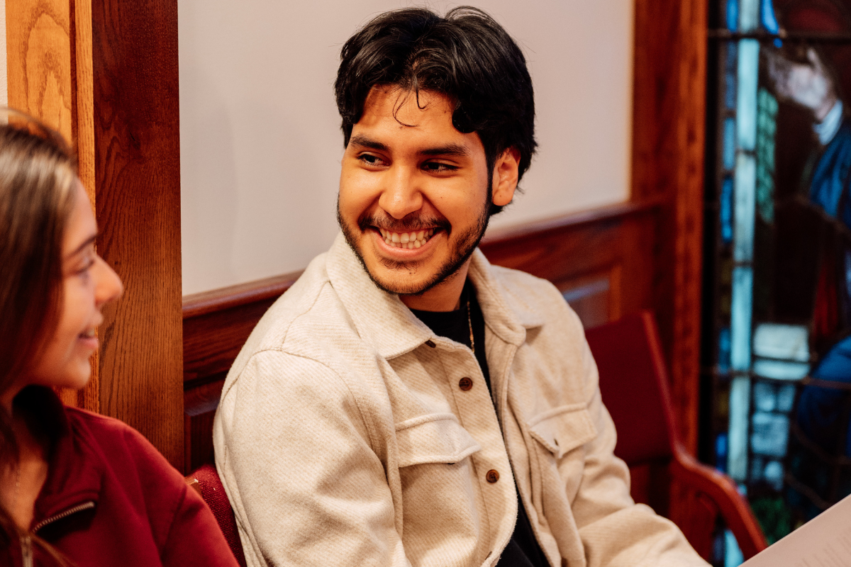 A student smiles during conversation