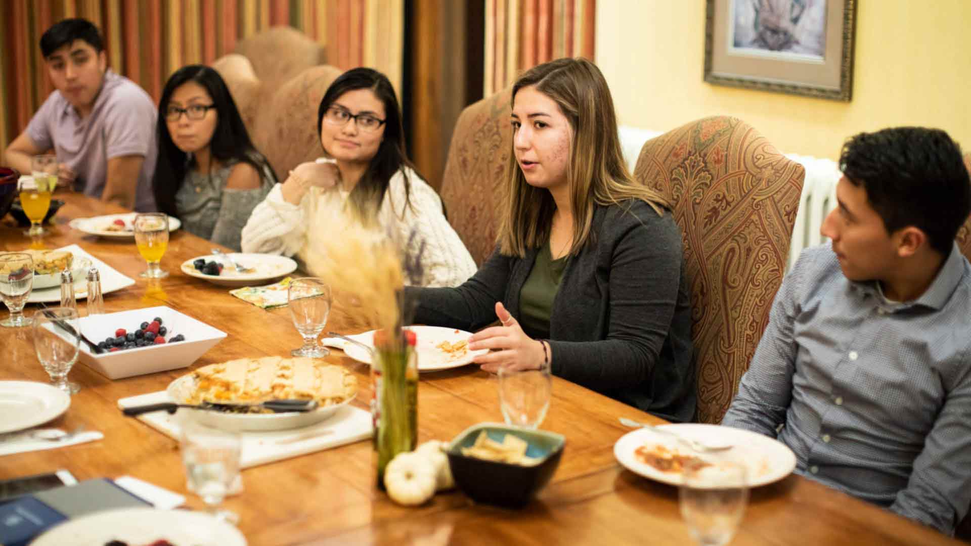 Members of the Latino Scholars Program gather for communal a dinner and discussion in Sitzmann Hall on the St. Paul campus.