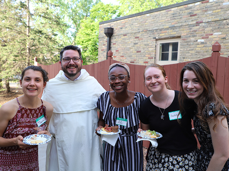 Catholic Studies graduate students with Father Austin Littke