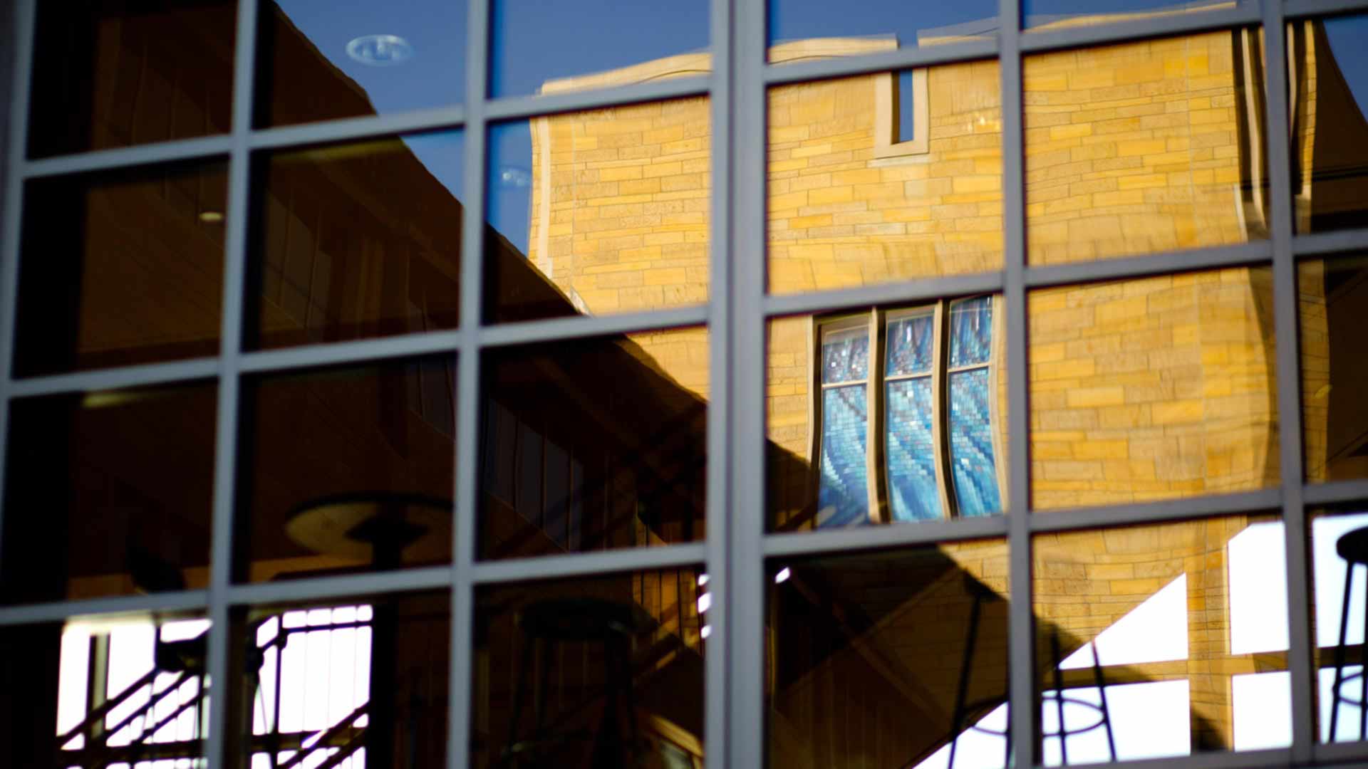 Owens Science Hall reflected in the windows of another building on the St. Thomas campus.