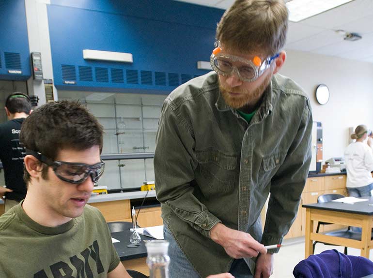 Dr. Tony Borgerding working with students in a chemistry lab.