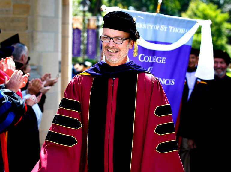Professor Mark Neuzil wears regalia during a procession