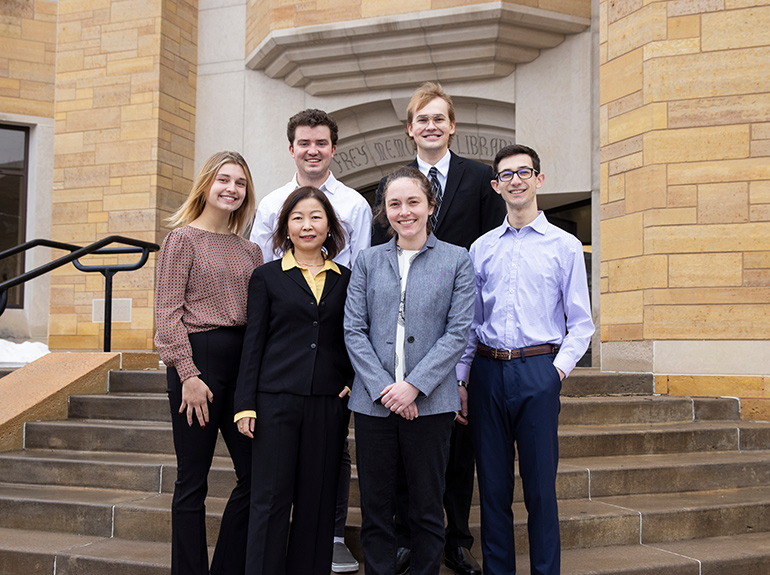 Econo faculty and students standing on the steps of the O’Shaughnessy-Frey Library