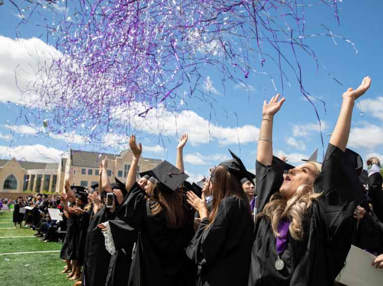 Graduates celebrate as confetti falls around them at the 2019 Undergraduate Commencement Ceremony.