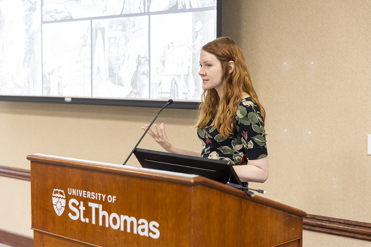 Cate Triola speaks at a podium
