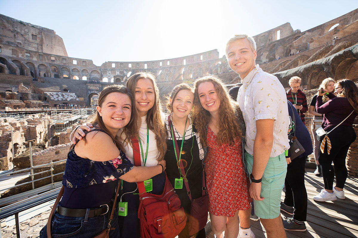 St. Thomas students on study abroad program in Rome, Italy pose for photos while on a tour of the Colosseum.