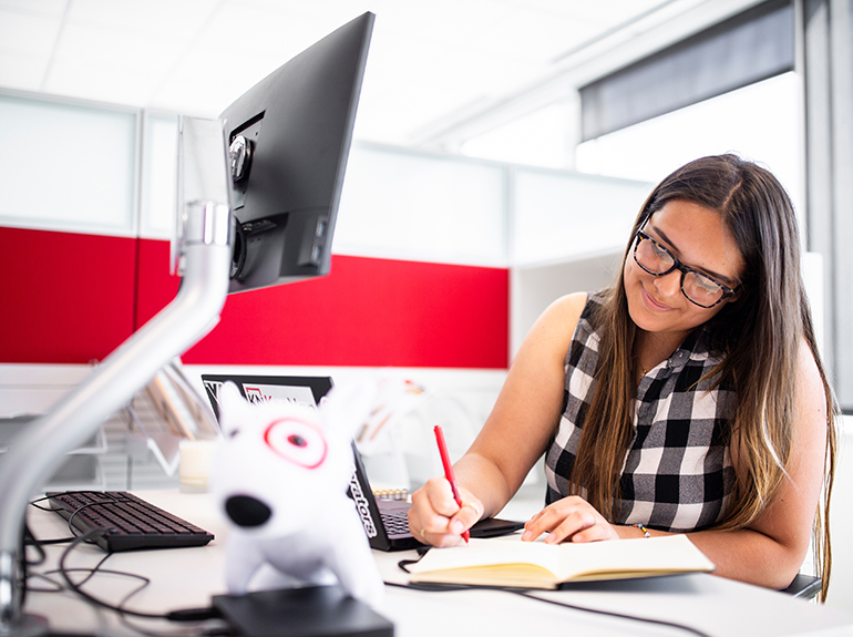 St. Thomas student Bea Valencia Martinez works at her desk at the Target headquarters during an internship.