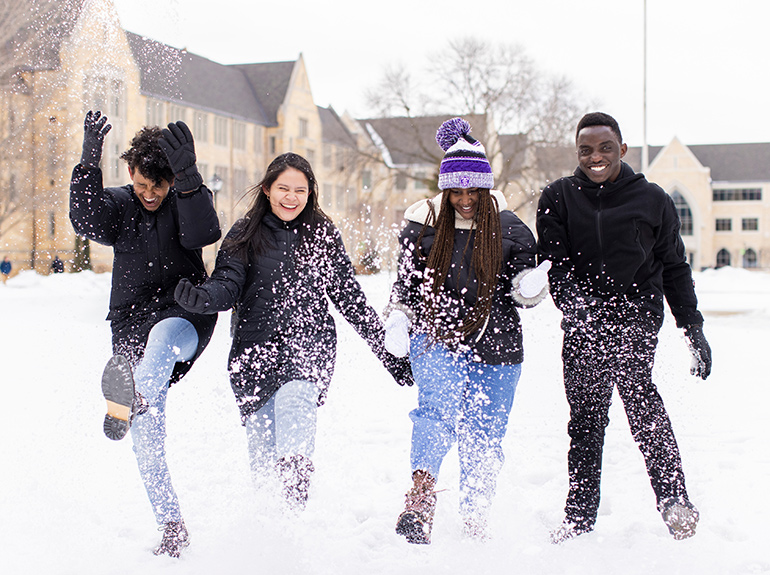 St. Thomas students play in snow on the quad