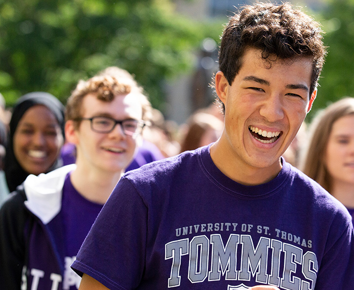 St. Thomas student smiling during during March Through the Arches.