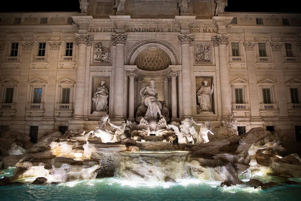 The Trevi Fountain in Rome, Italy lit up at night.
