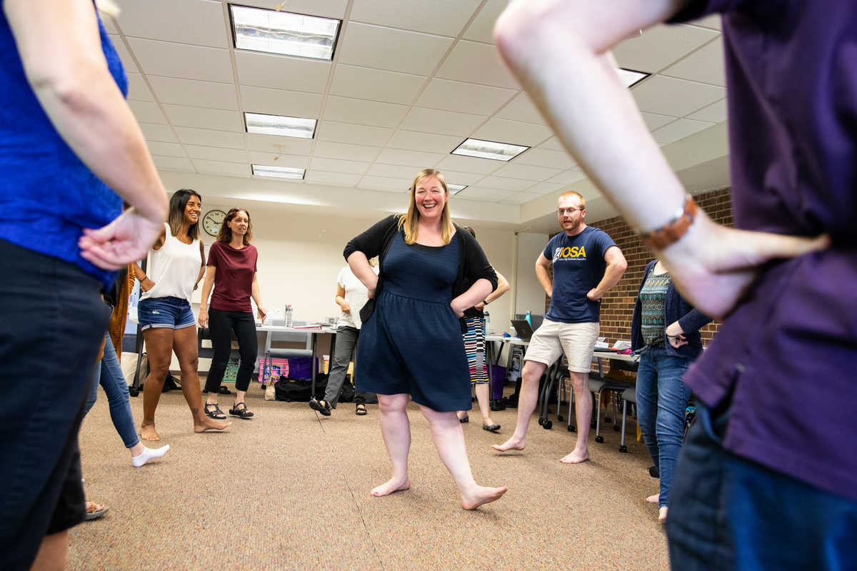 Students dance with each other during a class.