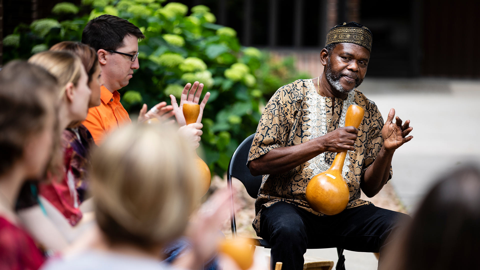 Prof. Sowah Mensah holds an instrument during an African Music Ensemble Concert