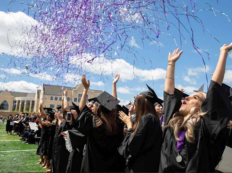 Graduates celebrate as confetti falls around them at the 2019 Undergraduate Commencement Ceremony. 